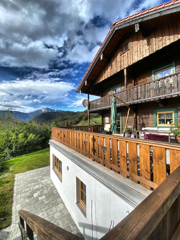 a large wooden building with a wooden balcony at Ferienwohnung Mariedei in Berchtesgaden