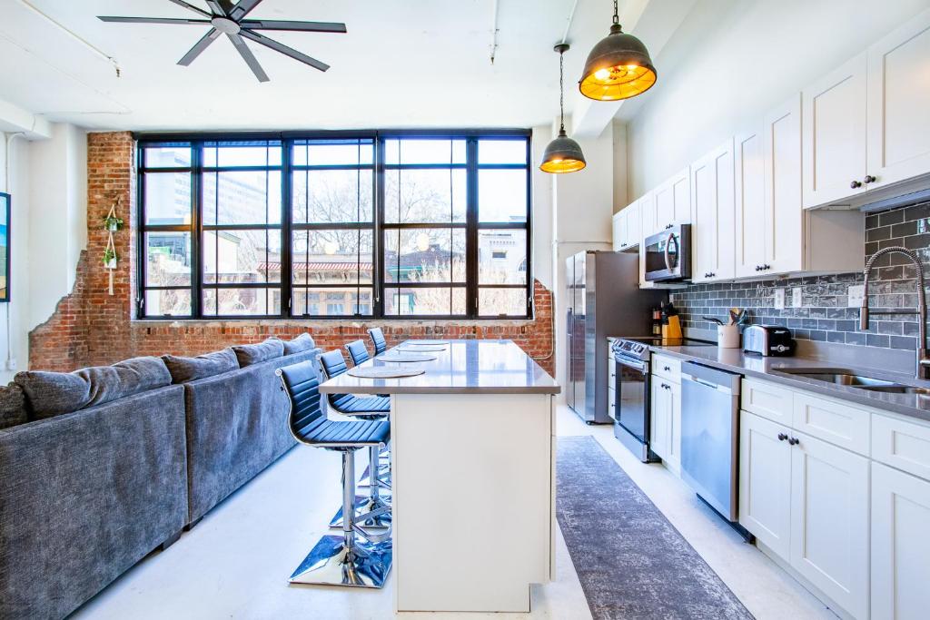 a kitchen with a couch and a table in a room at Spacious Sterchi Loft Getaway- Downtown Getaway in Knoxville