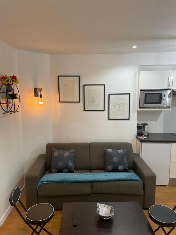 un salon avec un canapé et une table dans l'établissement Paris Cosy Apartment Opéra Vendome Galeries Lafayette, à Paris