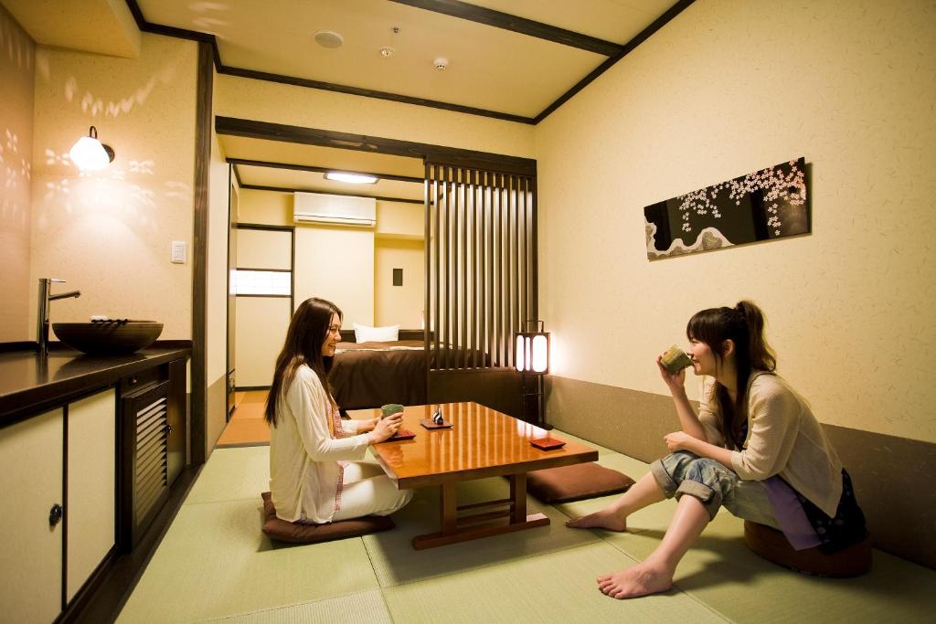 two women sitting around a table in a room at Takayama Ouan in Takayama