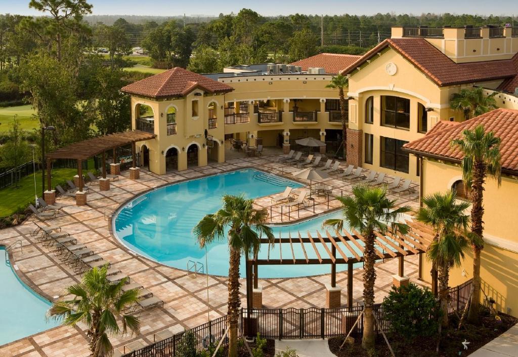 an aerial view of the pool at a resort with palm trees at The Berkley, Orlando in Orlando