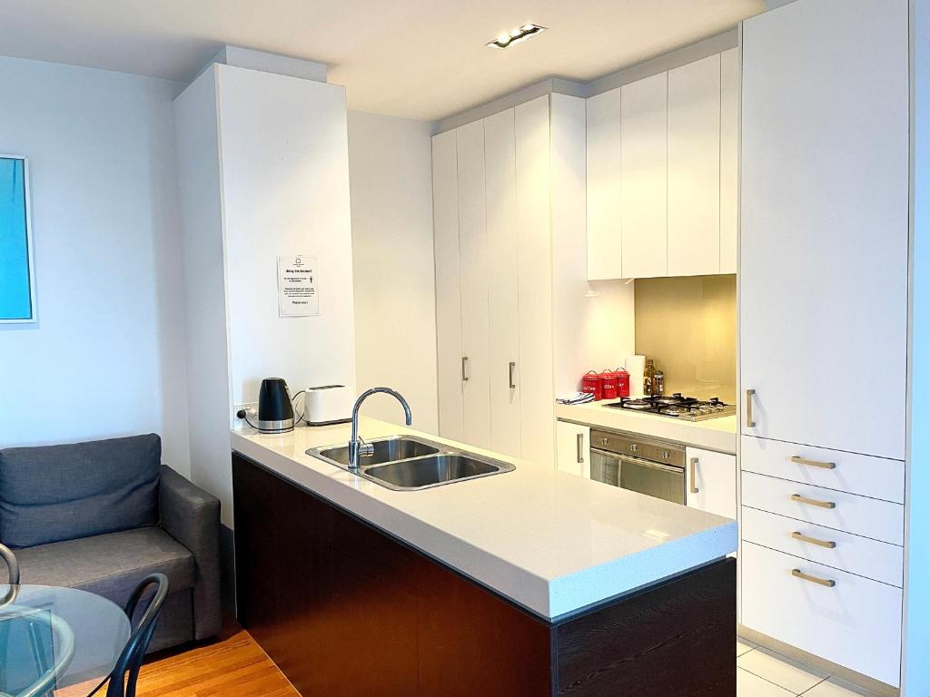 a kitchen with a sink and a counter top at Readyset Apartments at Verve in Melbourne