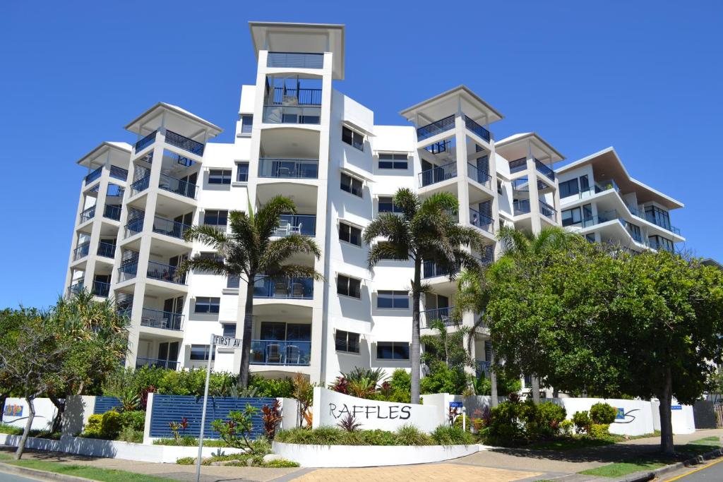 a large white building with a large window at Raffles Mooloolaba in Mooloolaba