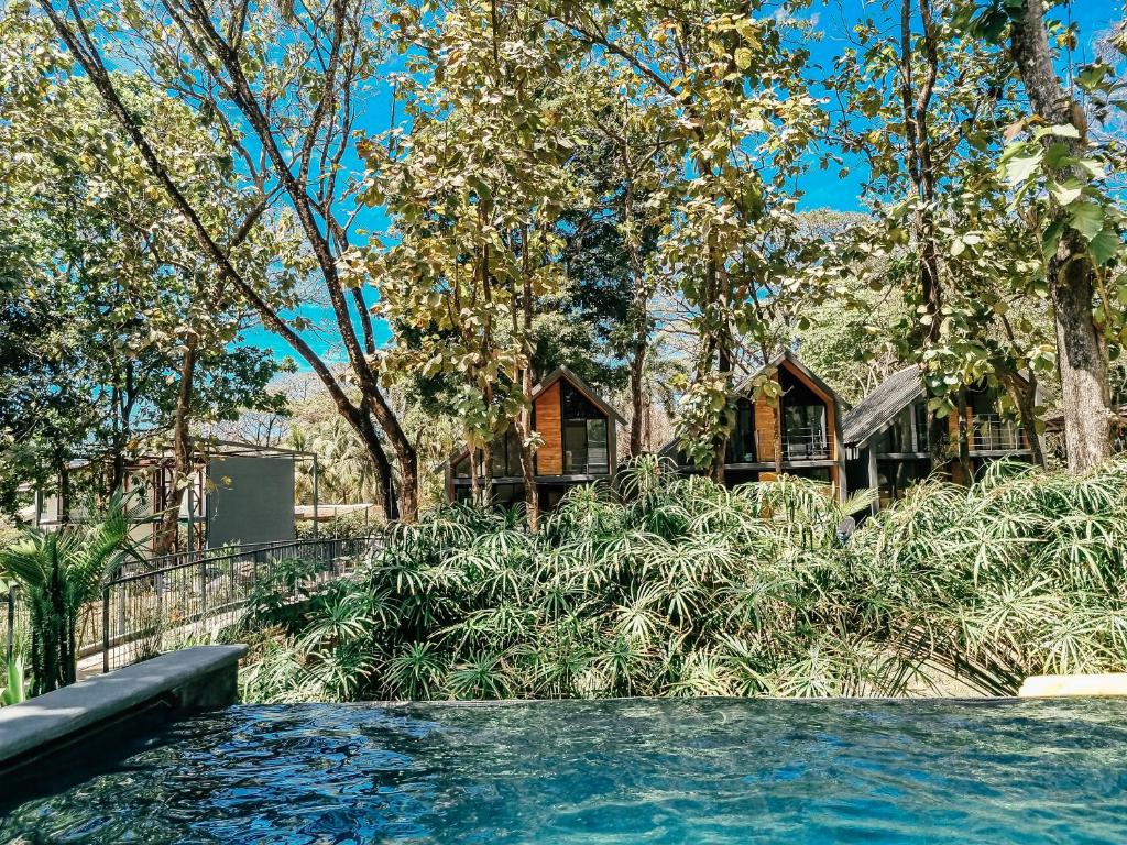 a swimming pool in front of a house at Little Escape in Santa Teresa Beach