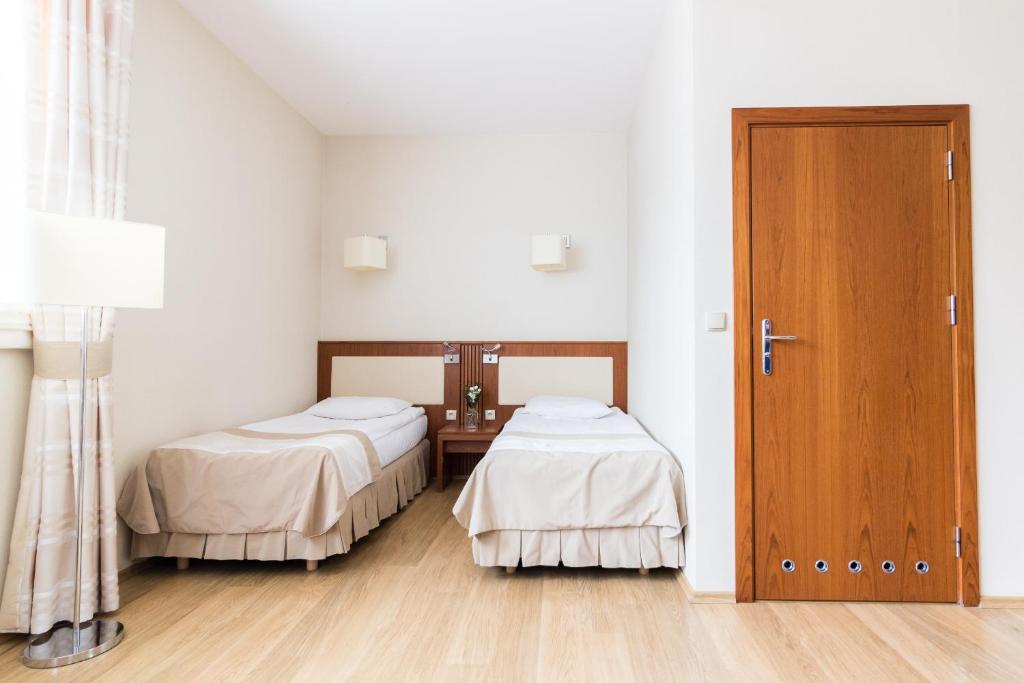 Posteľ alebo postele v izbe v ubytovaní Hotel Osada Karbówko Wellness & SPA