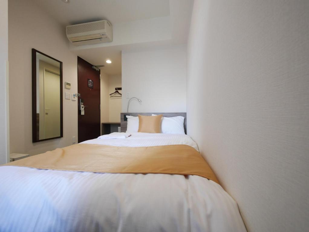 Postel nebo postele na pokoji v ubytování Hotel Comfybed Ginza