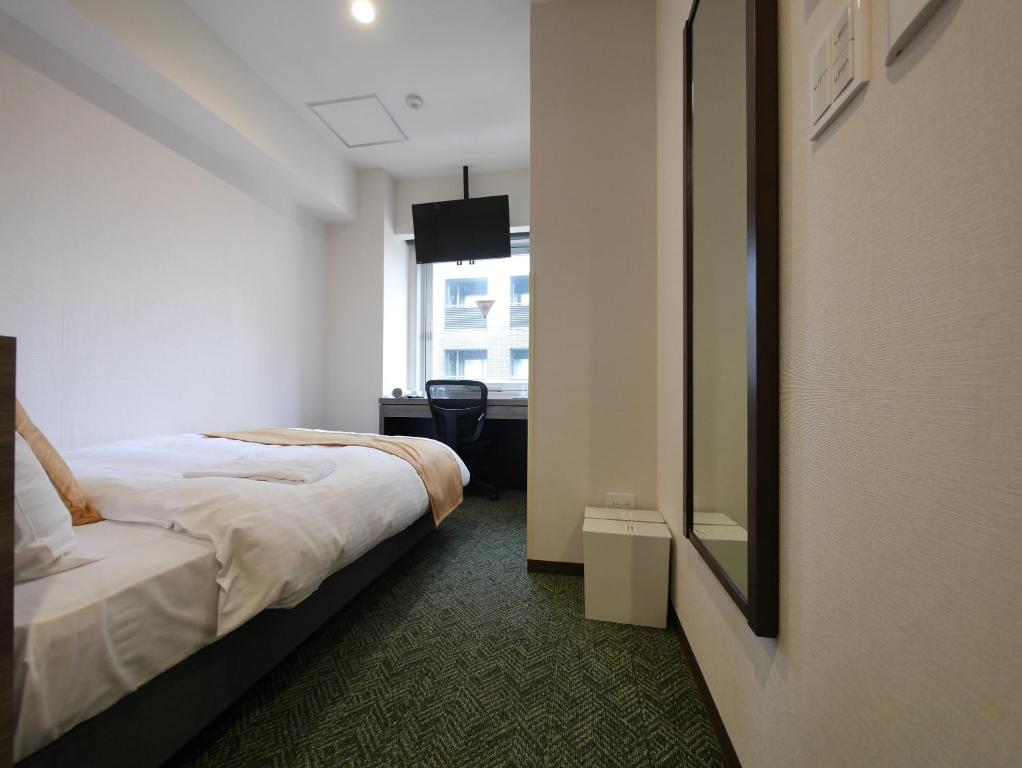 Postel nebo postele na pokoji v ubytování Hotel Comfybed Ginza
