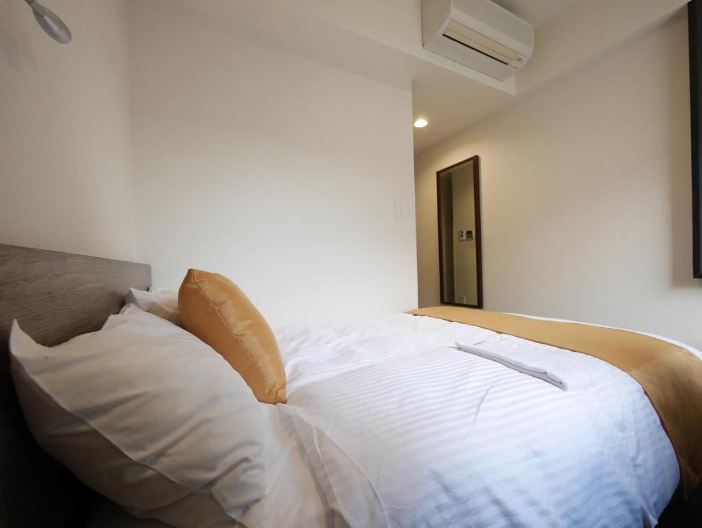 Postel nebo postele na pokoji v ubytování Hotel Comfybed Ginza