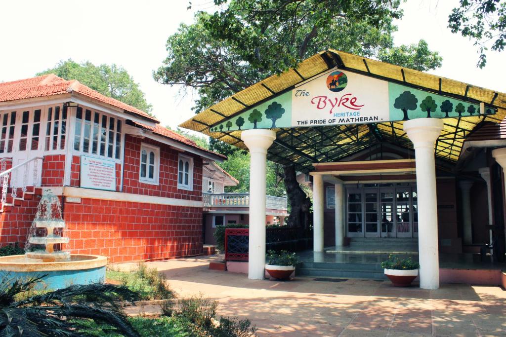 a building with a pavilion in front of a building at The Byke Heritage Matheran in Matheran
