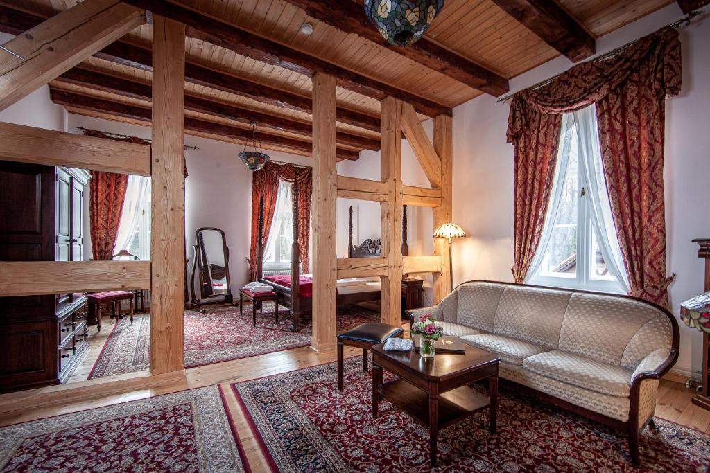 a living room with a couch and a table at Jagdschloss Waldsee in Waldsee