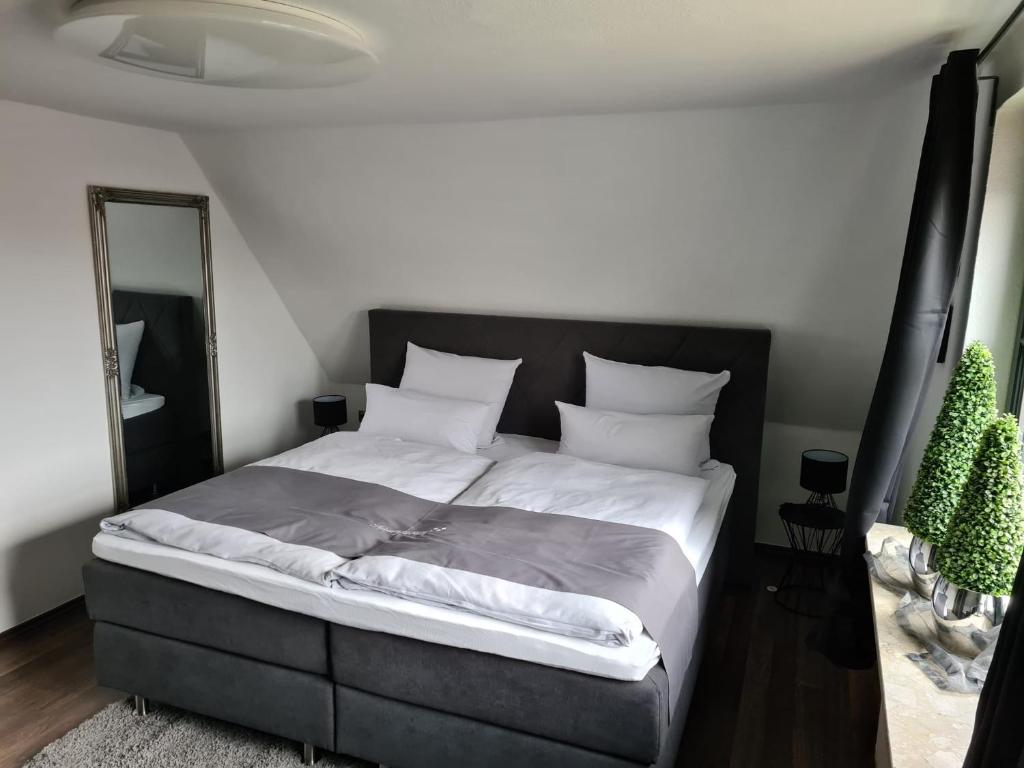 a bedroom with a large bed with a black headboard at Exklusive Ferienwohnung nahe der Nordsee in Wesselburen