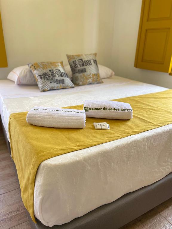 Postel nebo postele na pokoji v ubytování Palmar de Jericó Suites