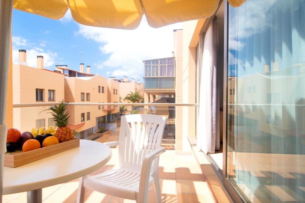 a balcony with a table and chairs on a balcony at 2BR Home next to Esquinzo Beach - Terrace in Pájara