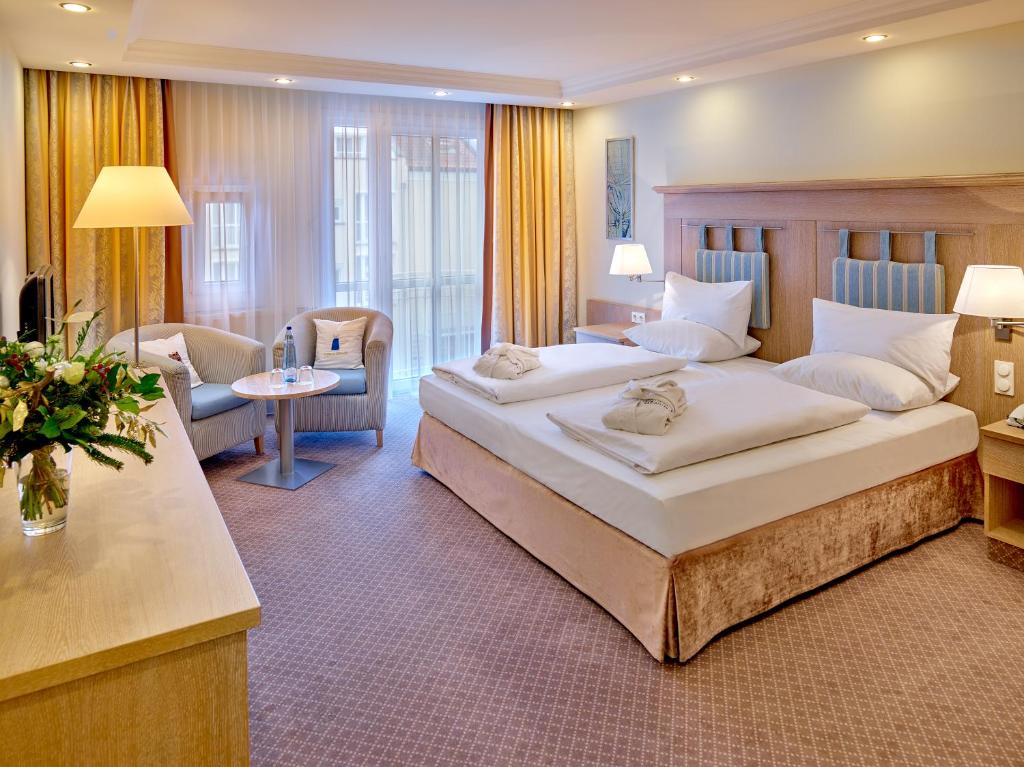 Postel nebo postele na pokoji v ubytování Hotel Maximilian