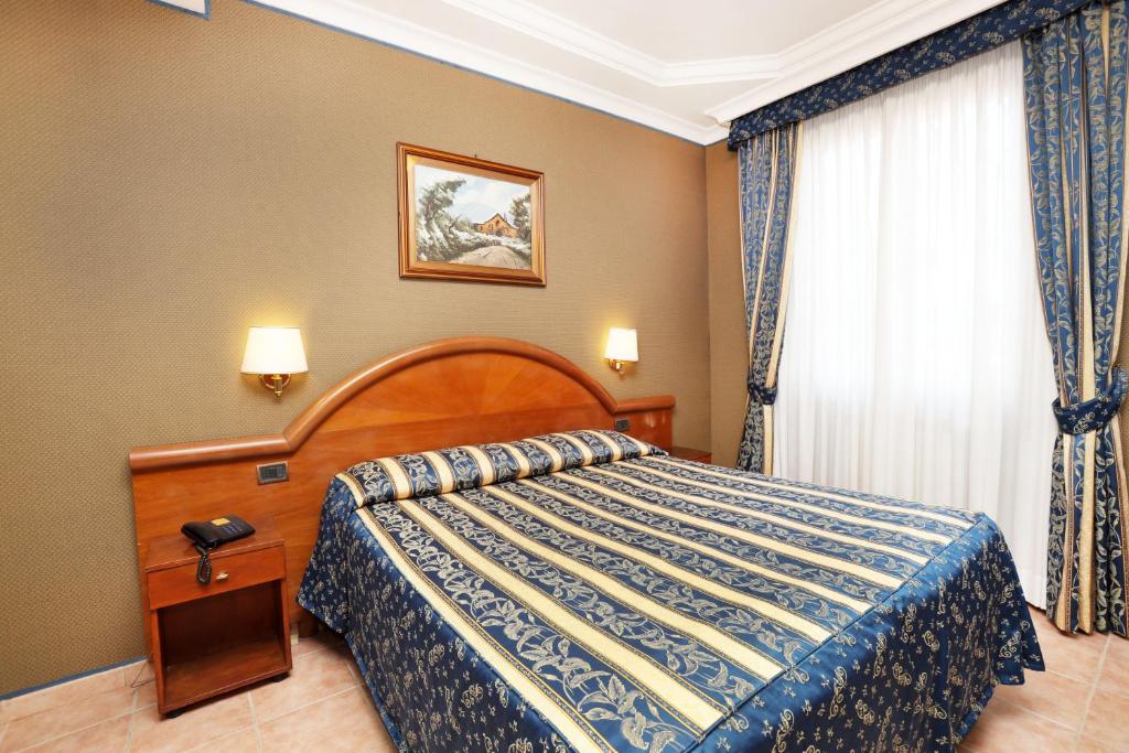 Postel nebo postele na pokoji v ubytování Hotel Rimini
