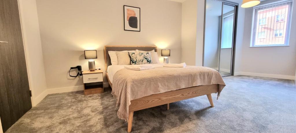 a bedroom with a bed and a nightstand and a window at Seven Living Residences Slough - City Apartments, Free Parking in Slough