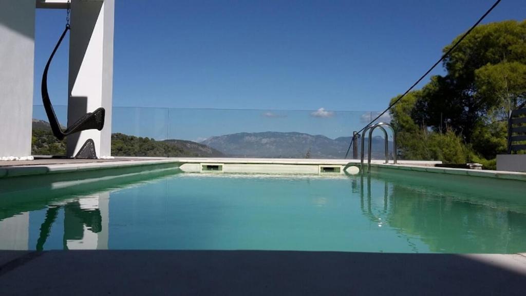 a pool of water with a slide in a building at Luxurius villa with sea view in Korinthos