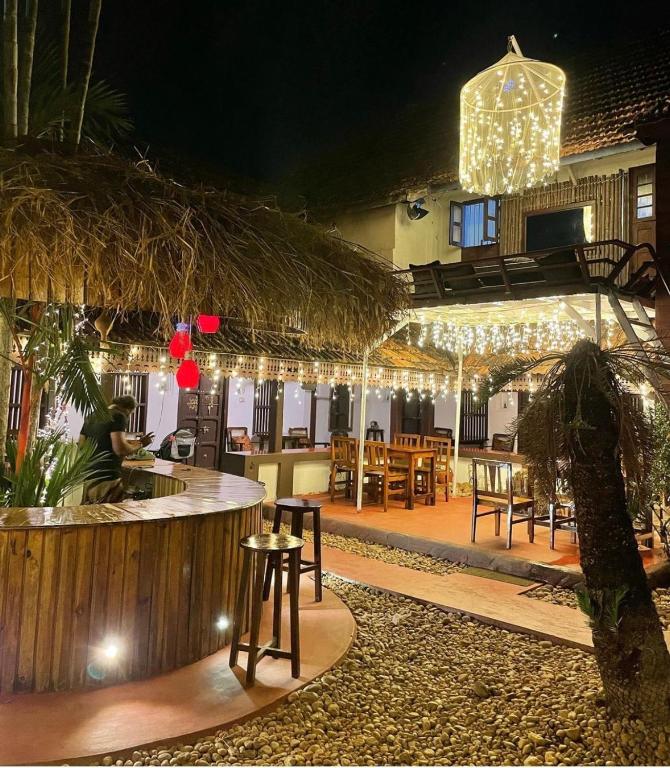 a restaurant with a bar with tables and chairs at Vrindavanam Heritage Home in Alleppey