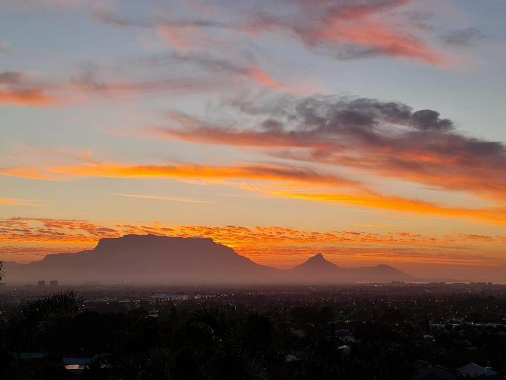 a sunset with a view of the table mountain at Palm Zicht in Cape Town