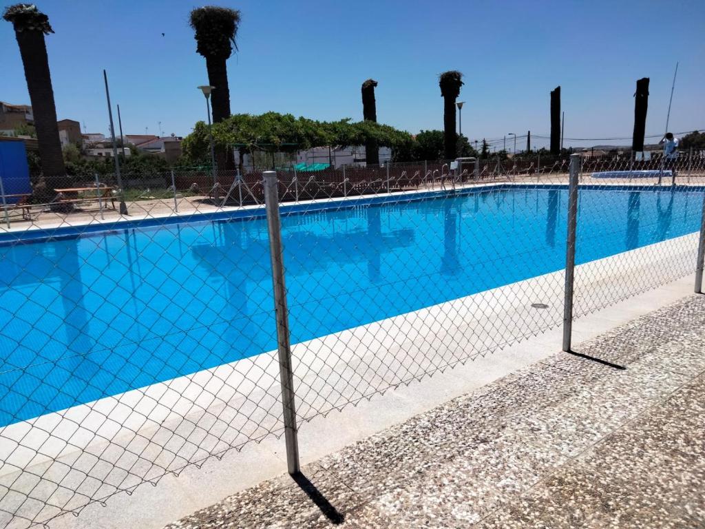 a swimming pool with a fence around it at Caserío de Vazquez 5 in Castilblanco de los Arroyos