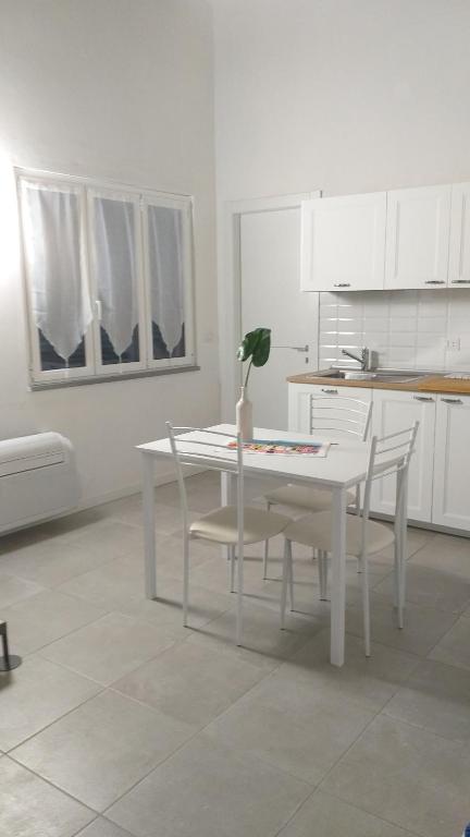 a kitchen with a table, chairs, and a table cloth at Residenza Solferino in Corniglia