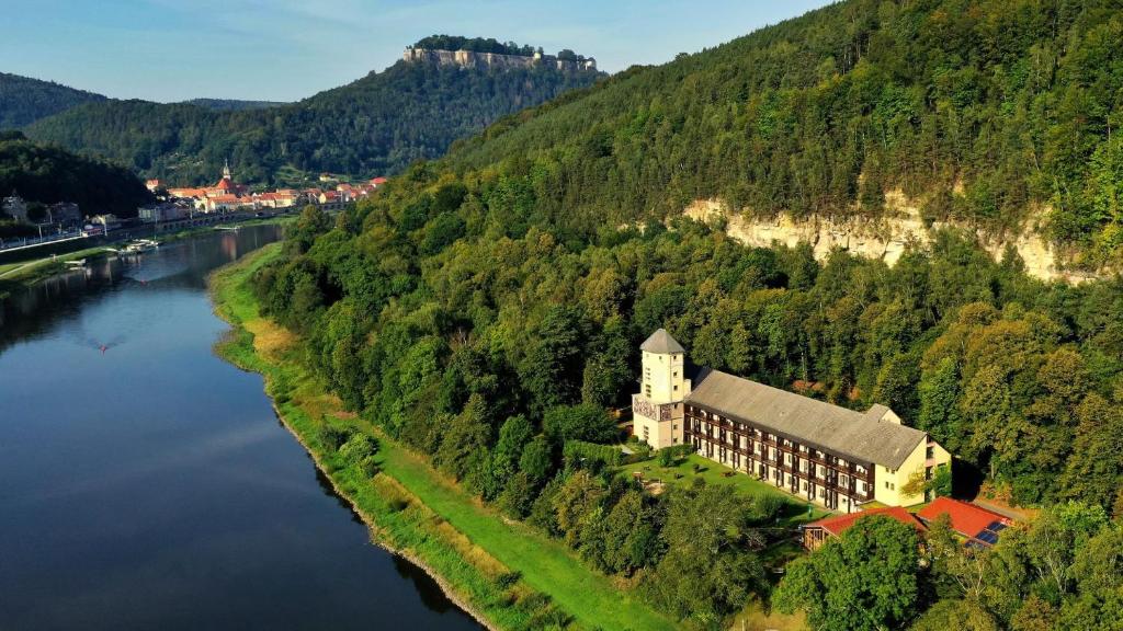 an aerial view of a building next to a river at Aktiv-Hotel Stock & Stein in Königstein an der Elbe