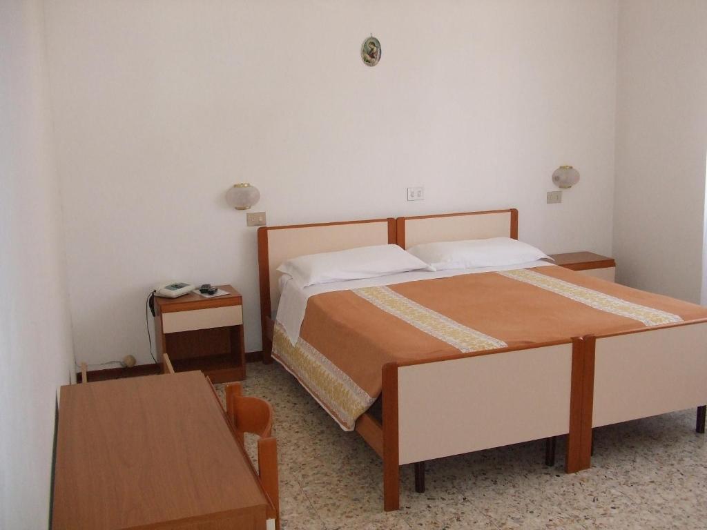 Postel nebo postele na pokoji v ubytování Albergo La Primula