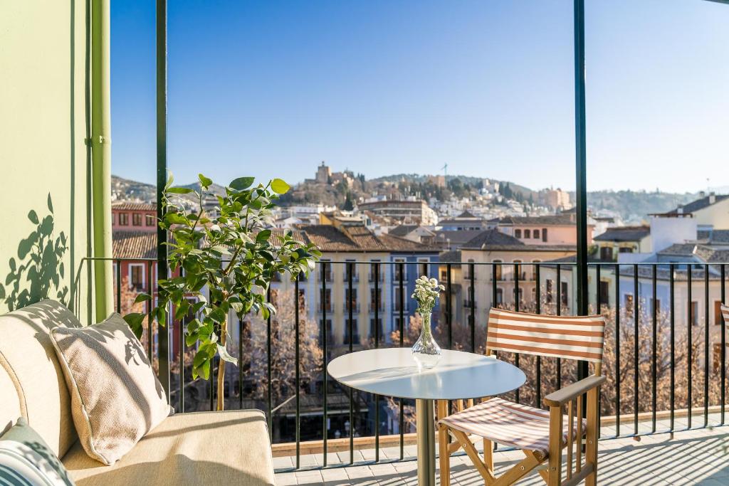 balcón con mesa, sillas y vistas en U-Sense Granada Centro, en Granada