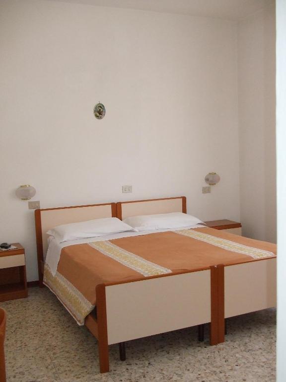 Postel nebo postele na pokoji v ubytování Albergo La Primula