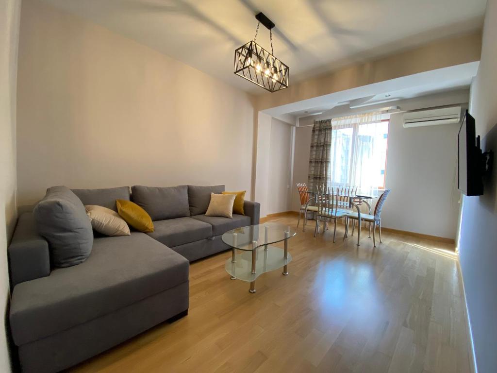 a living room with a couch and a table at Northern Avenue Apartment in Yerevan