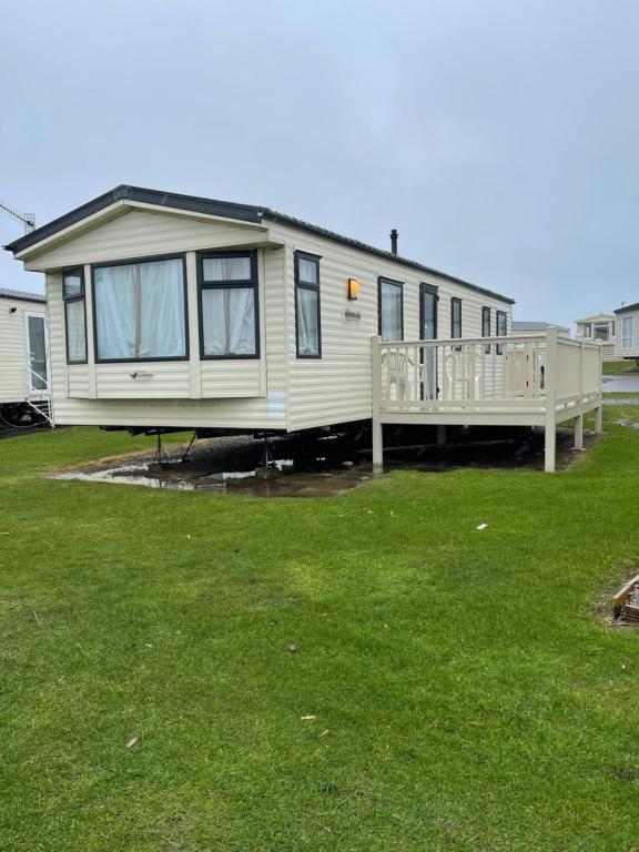 a mobile home with a porch and a deck at The Westmorland in Eyemouth