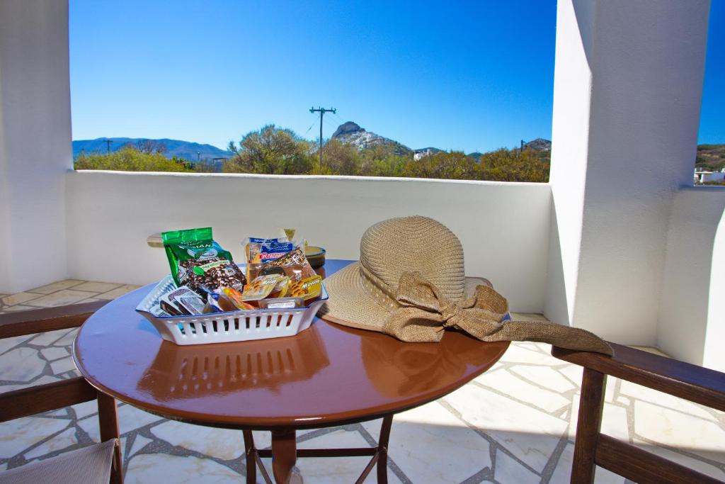 a hat and a basket of food on a table at To Pithari in Skiros