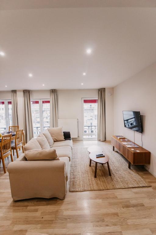 a living room with a couch and a table at Central and Cozy in Brussels in Brussels