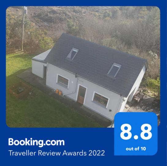a picture of a white house with a sign that says travel review awards at Connemara Chalet in Galway