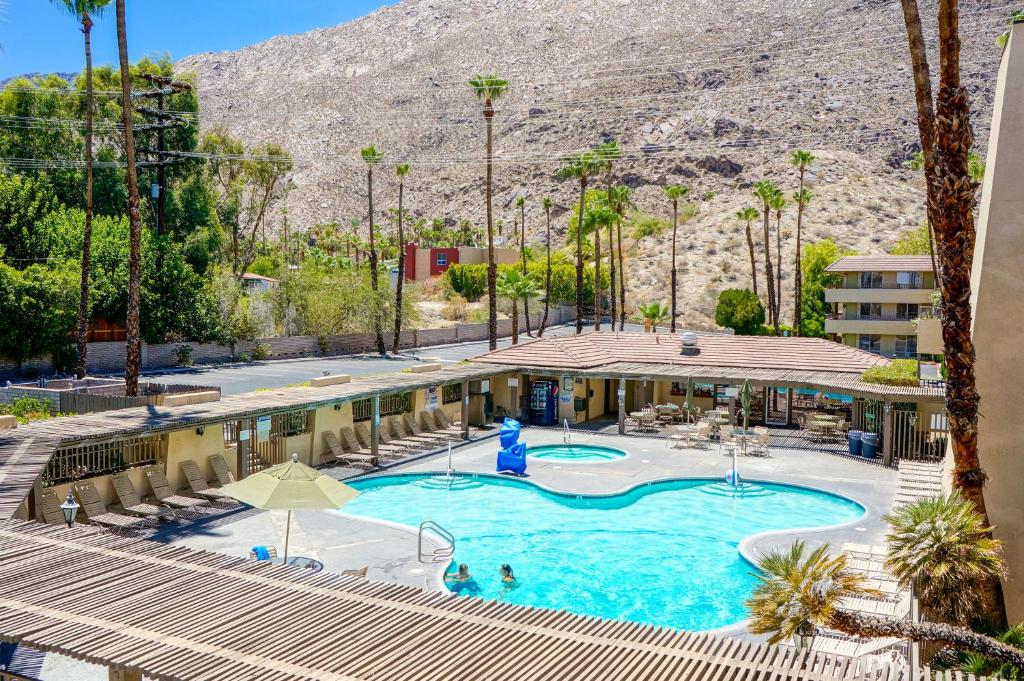 a pool in a hotel with a mountain in the background at Vagabond Motor Hotel - Palm Springs in Palm Springs