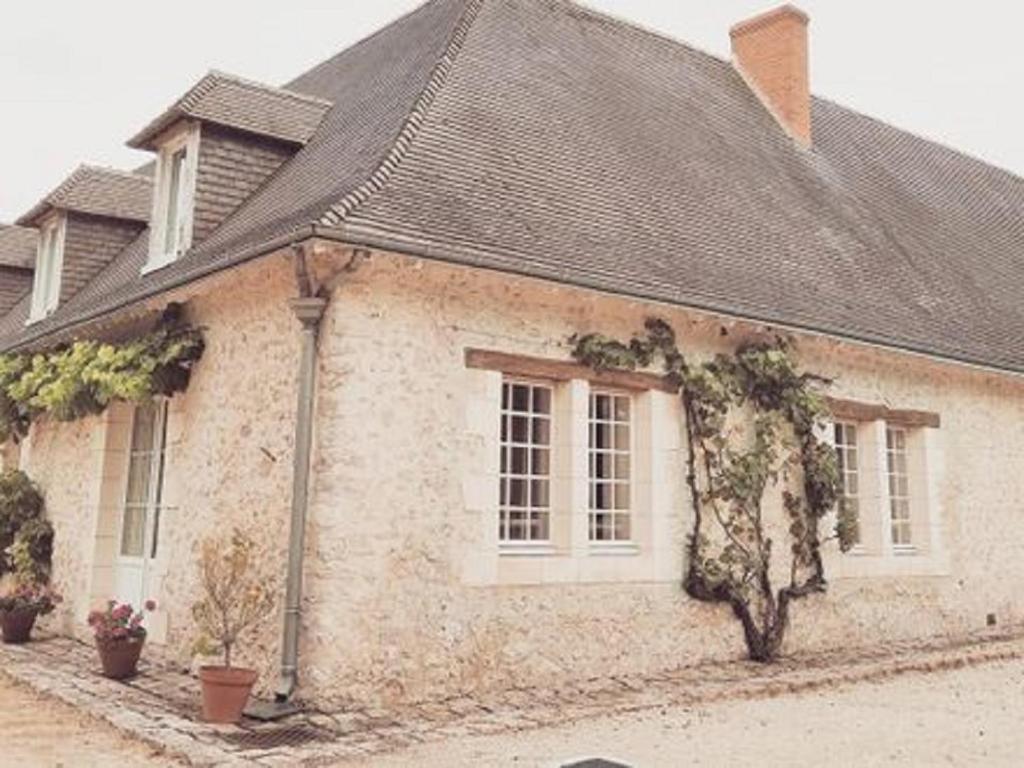 una casa de ladrillo blanco con techo negro en LES GRANGES D'ANTAN - La FORGE -, en Chalonnes-sous-le-Lude