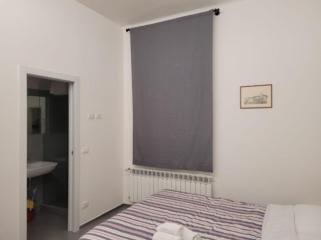 Habitación blanca con cama y lavabo en Zio Toto' en Bolonia