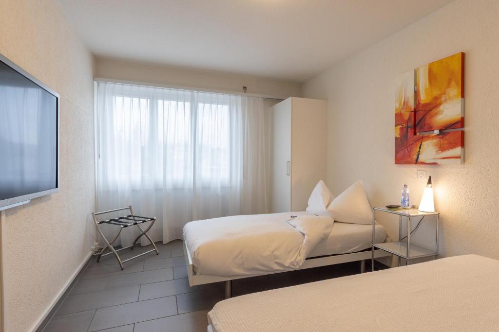 Postel nebo postele na pokoji v ubytování Hotel Bären Niederscherli