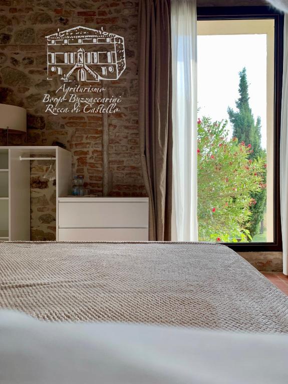 Postel nebo postele na pokoji v ubytování Agriturismo Borgo Buzzaccarini Rocca di Castello