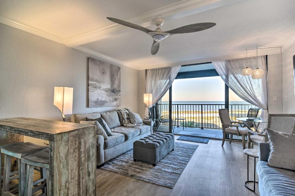 a living room with a couch and a table at Beachfront Clearwater Condo with Community Pool in Clearwater Beach