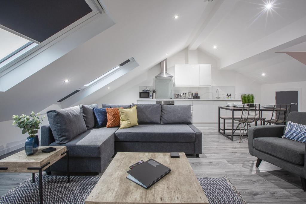 a living room with a couch and a table at Charles Alexander Short Stay - The Gateway in Blackpool