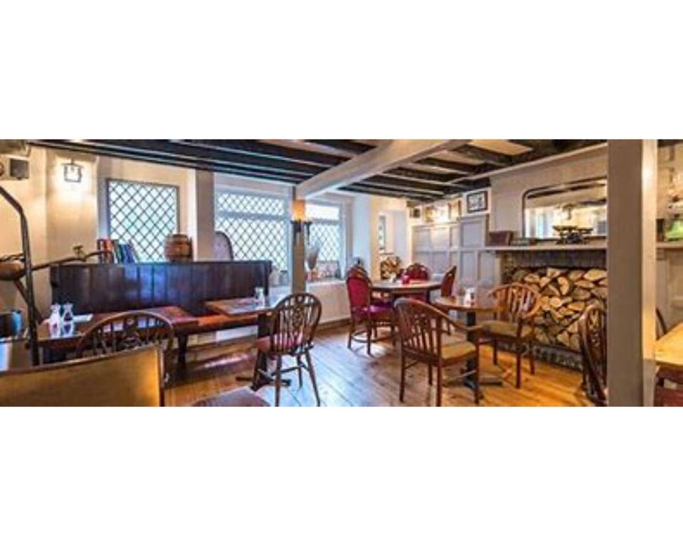 a living room with tables and chairs and a dining room at Seven Stars in Dartmouth