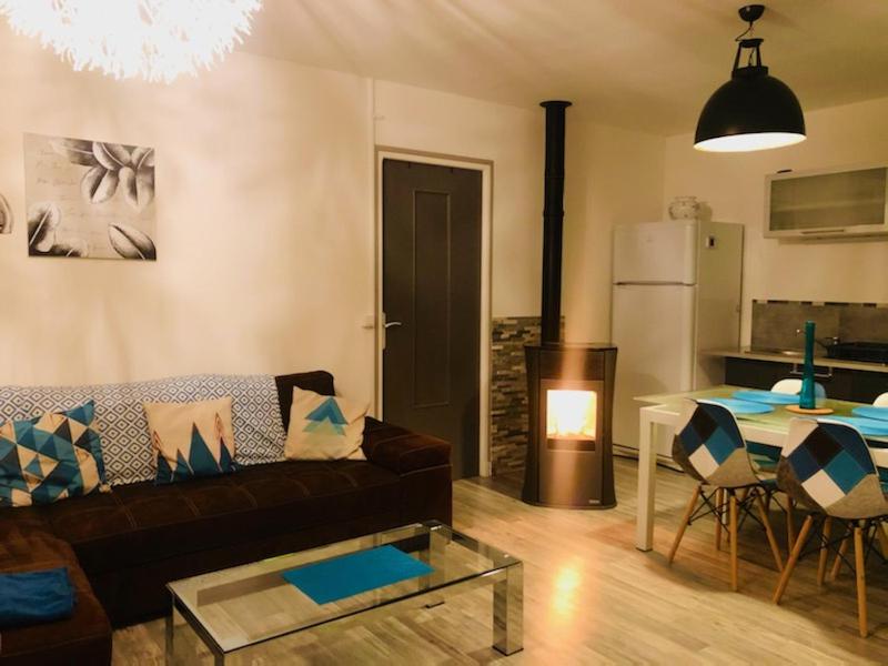 a living room with a couch and a table at Gîtes de Chauvet in Gap