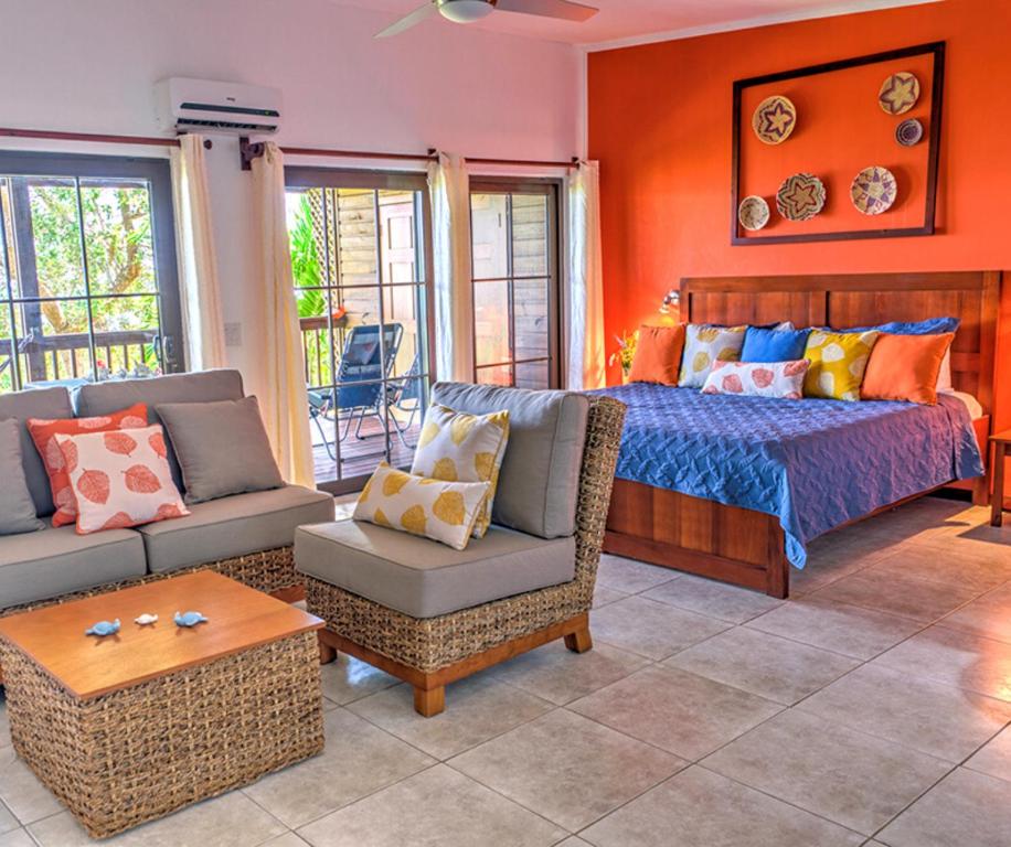 a bedroom with a bed and a couch and a table at The Resort at Marble Hill in Diamond Rock