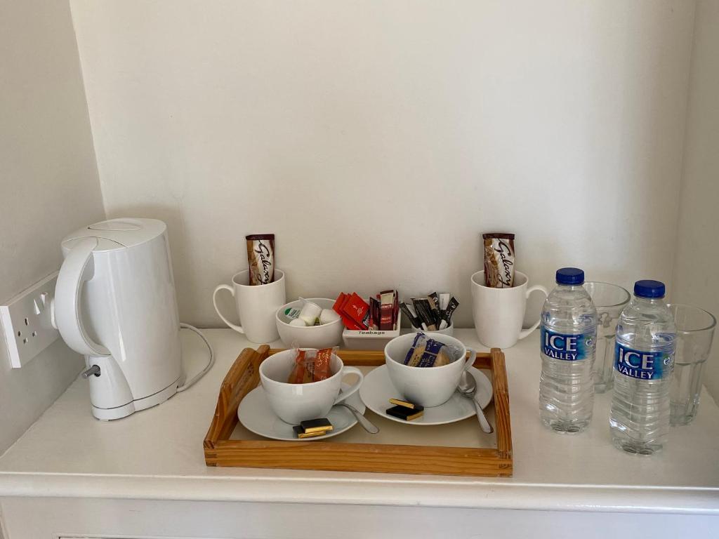 a tray with bowls and bottles of water on a counter at Gretenham B&B in Swanage