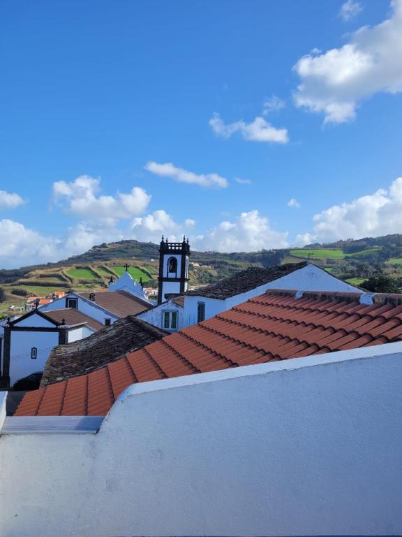 a view from the roof of a building with a clock tower at The Handmade House Azores in Porto Formoso