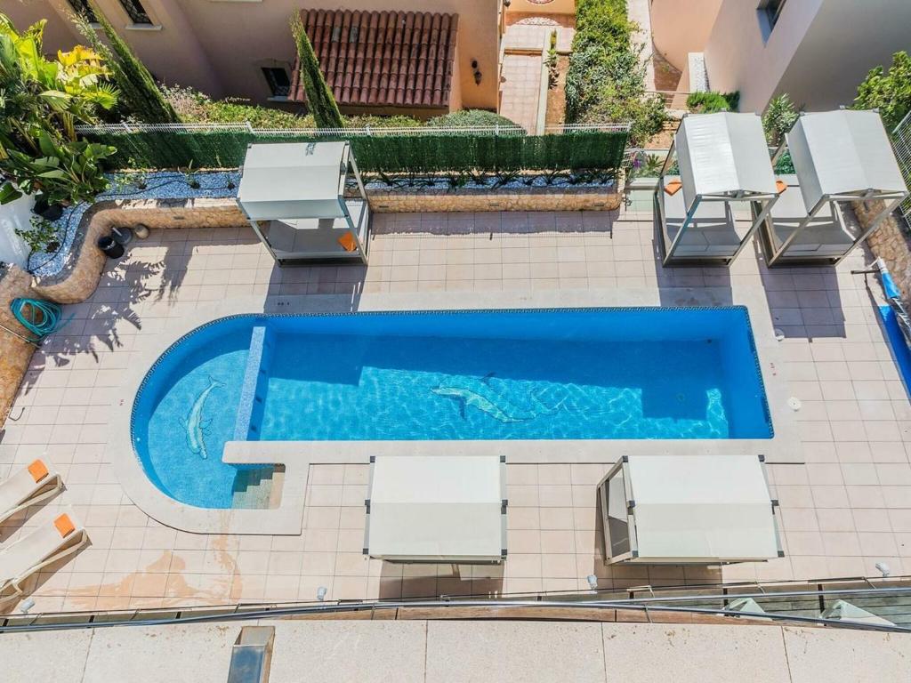 an overhead view of a swimming pool with two lounge chairs and a swimming pool at Belvilla by OYO Sammy in Port d'Alcudia