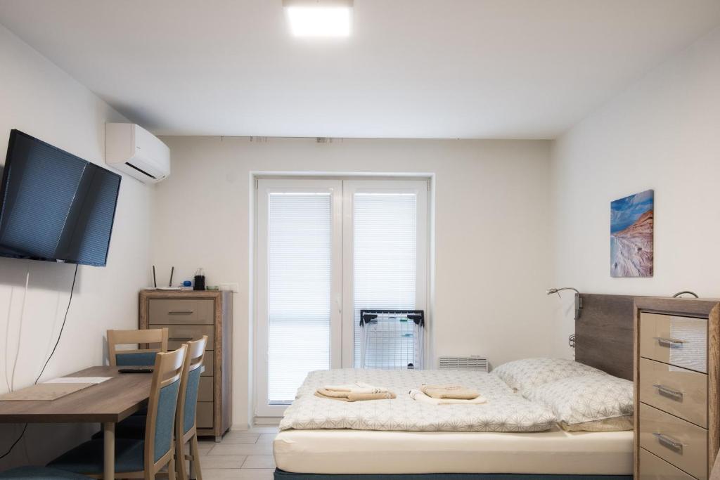 Postel nebo postele na pokoji v ubytování Apartmany Arcadia