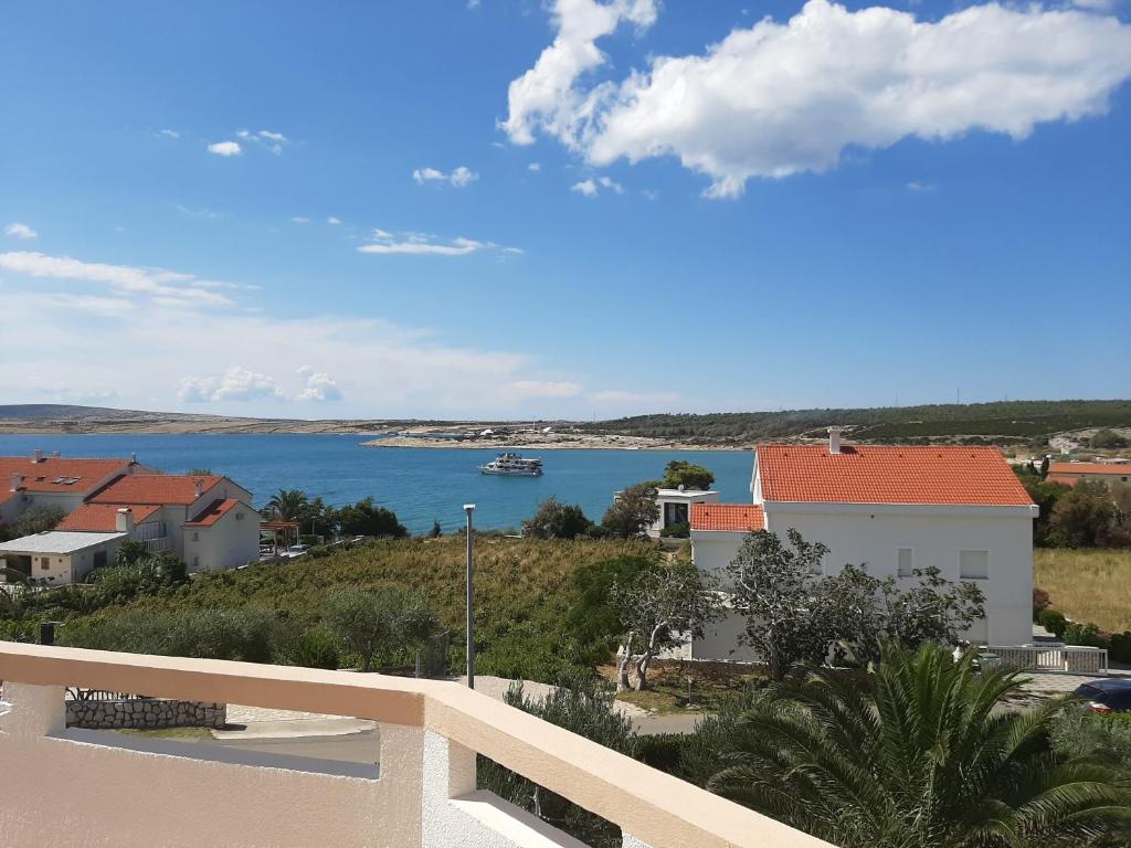 a view of a body of water from a balcony at Apartments Donadic II, Caska in Novalja