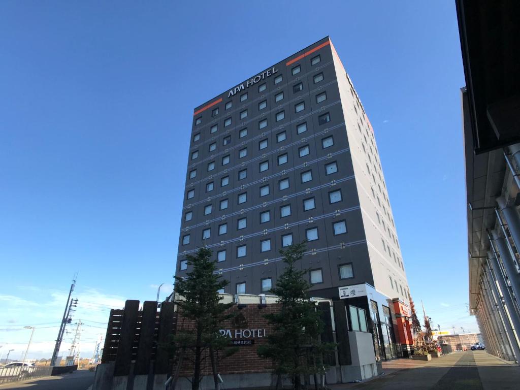 a tall building with a sign on the side of it at APA Hotel Joetsu Myoko-Ekimae in Joetsu